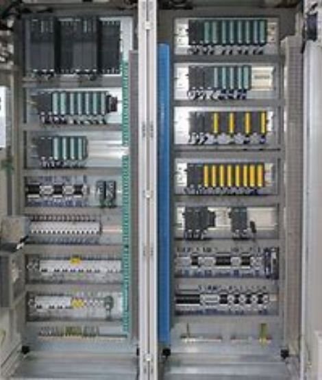 Inside view of a process automation panel with PLCs and relays
