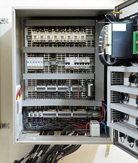 A large industrial automation control panel with multiple VFDs and PLCs